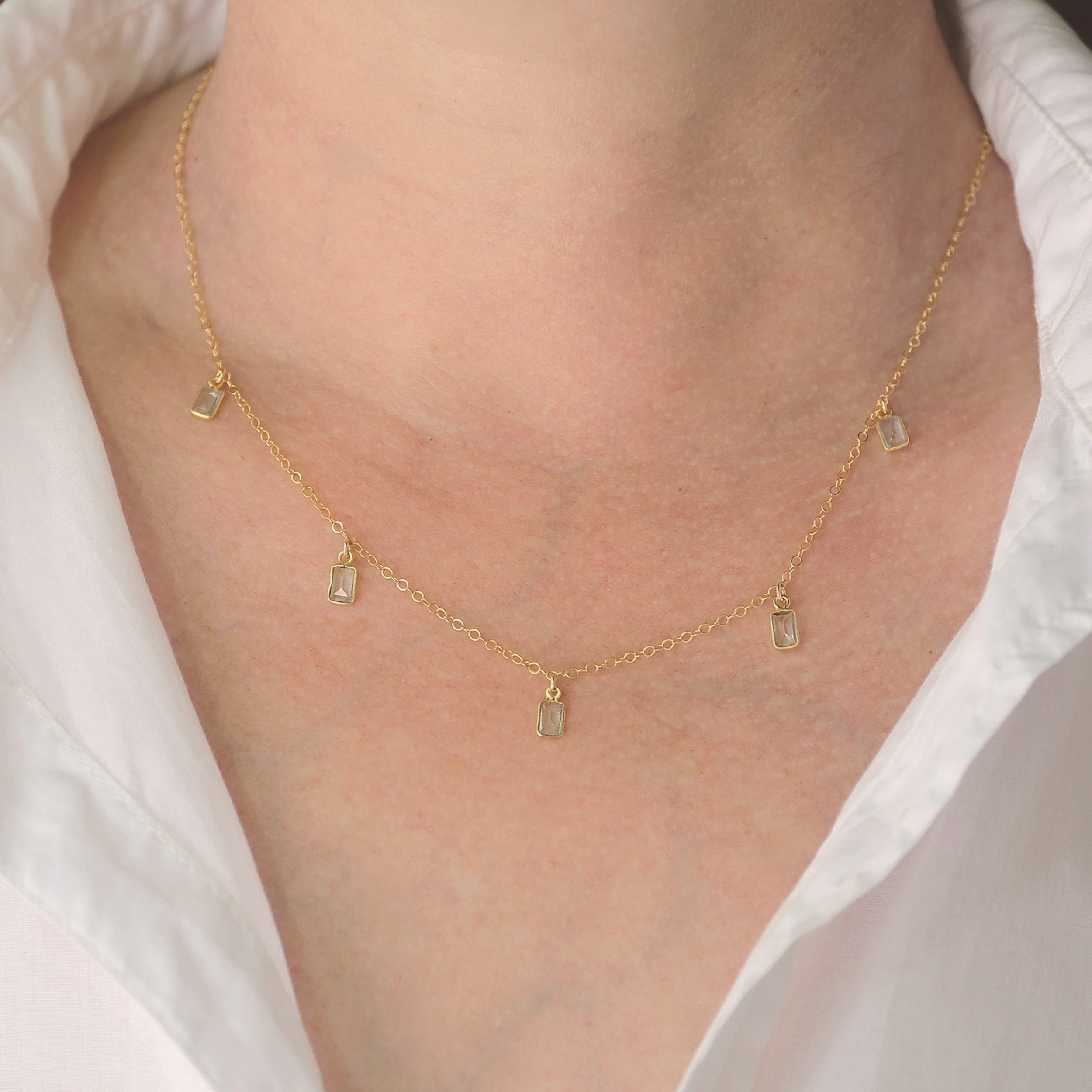 Gold aquamarine necklace with faceted gemstone charms