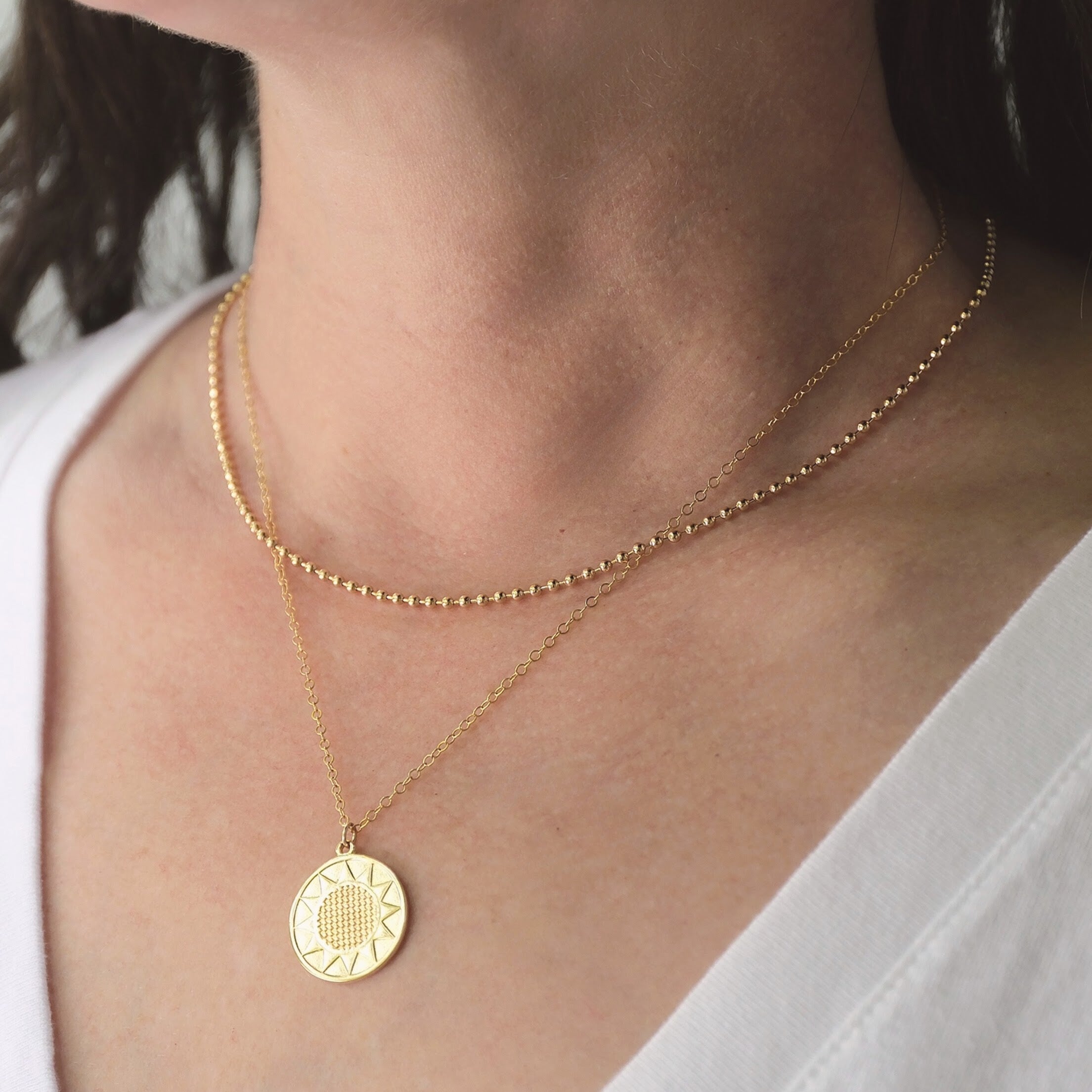 Gold sun pendant necklace