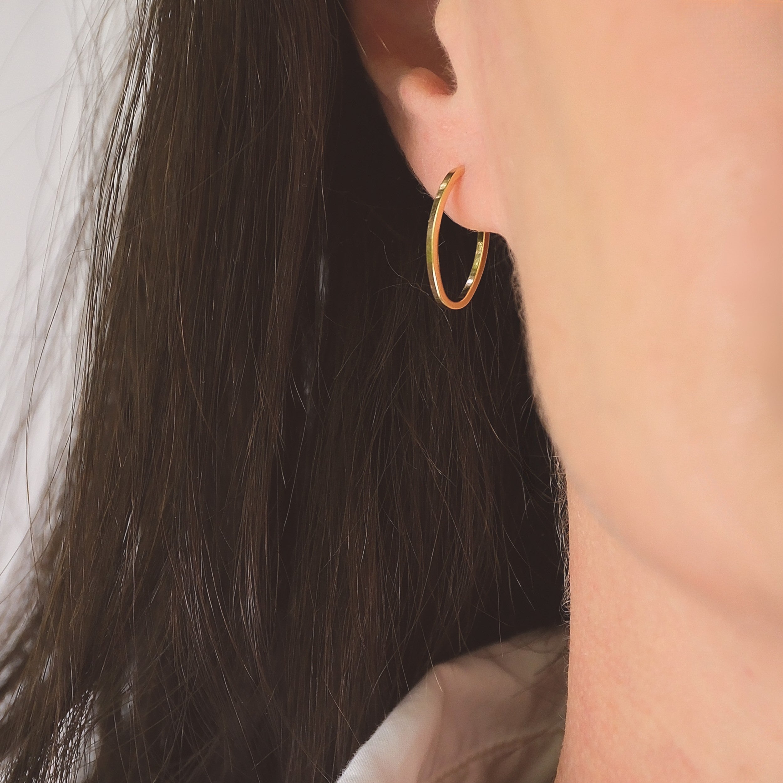 Gold oval-shaped huggie earrings